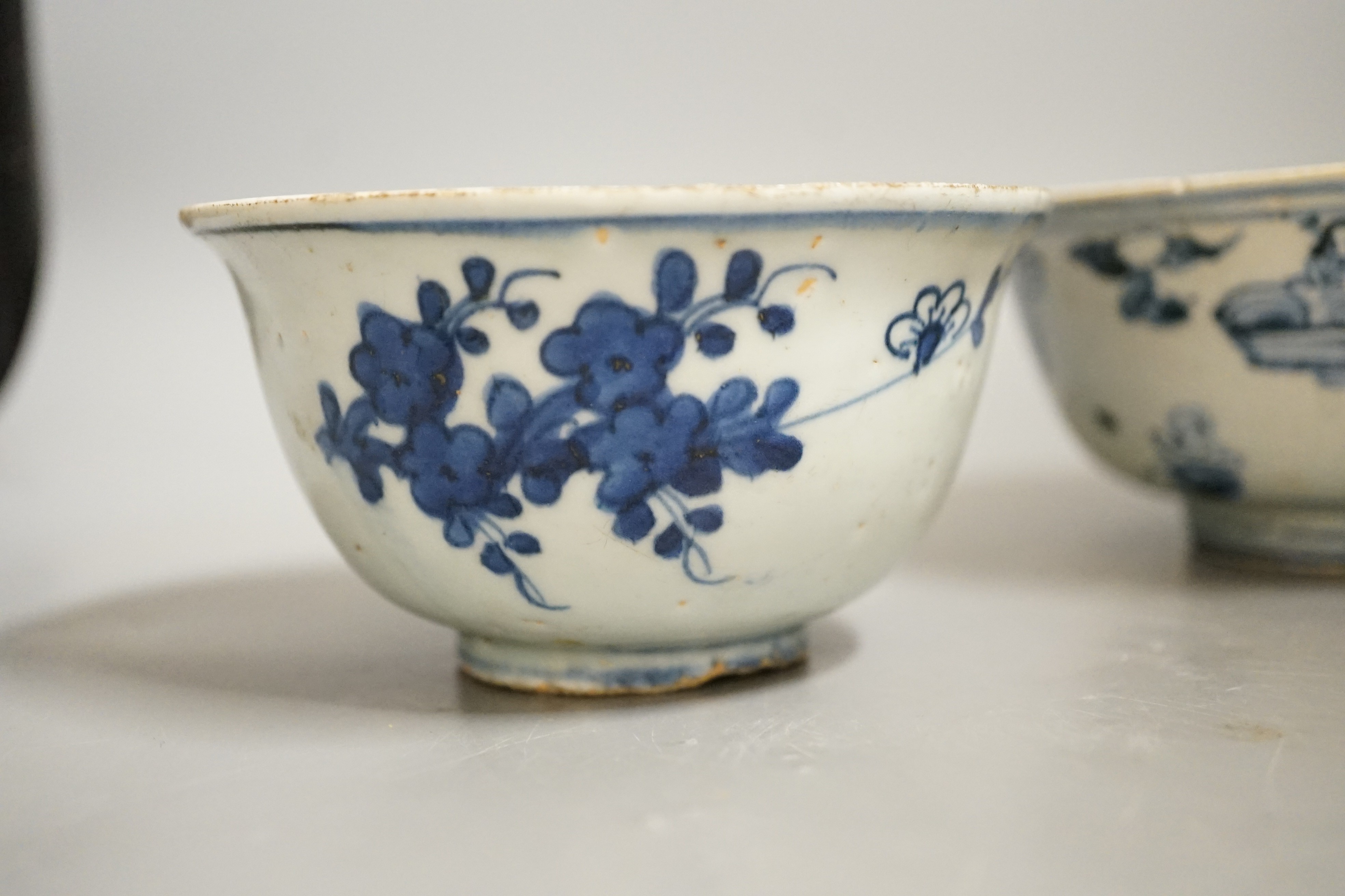 Three Chinese late Ming blue and white bowls, one painted with figures in a boat on horseback and in the landscape, the second with floral sprays, with ‘Made in the Great Ming dynasty’ mark and another bowl, largest 13.3